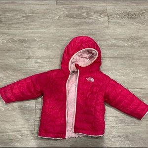 Warm and cozy 6-12 months North Face pink jacket.